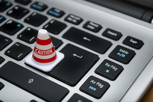 Caution Cone sitting on a laptop keyboard