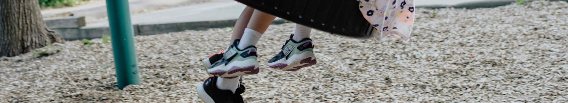 Children playing on tire swing